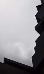 an airplane flying in the air near a building