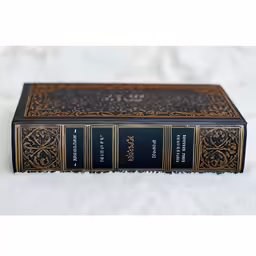 a book sits on a white cloth on a table