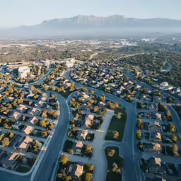 aerial view of residential streets and mountains in the background