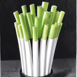 some plastic green and white tubes are in a vase