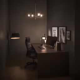 an office with a dark colored wall and wooden desk