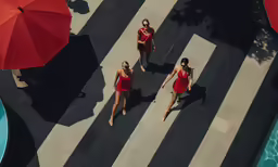 three women in red are on the walkway
