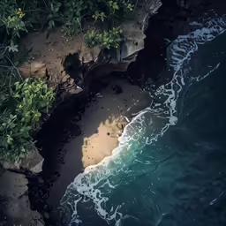 an aerial view of a rocky shore near the water