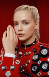 the model is posing with her hand on her chin