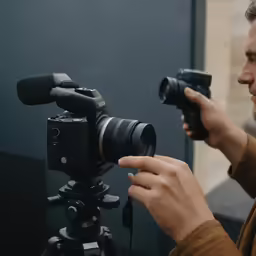 a man holding up a camera to take a photo