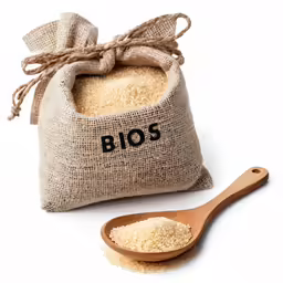 a bag of flour on a wooden spoon with a sack next to it