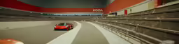 a red sports car driving along an empty track