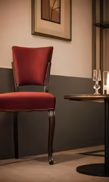 the chair with the arm rests against a grey wall