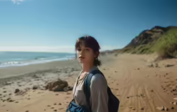 a young girl walking along the beach