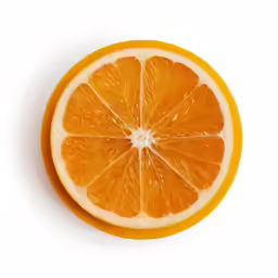 a cut orange sitting on top of a white table