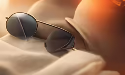 a pair of black sunglasses on top of a couch