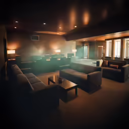 a room filled with black couches and green chairs