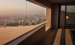 a balcony overlooking the city, with the mountains visible