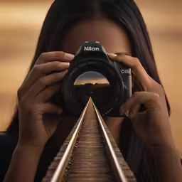 a person taking a picture with a camera on a train track