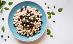 a blue bowl filled with beans and veggies