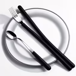 two forks and two spoons on a plate