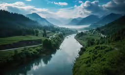 a river in the middle of mountains and clouds