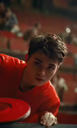 a young boy looks at the camera while holding onto a plate