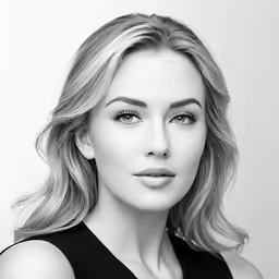 a woman with blonde hair posing for the camera