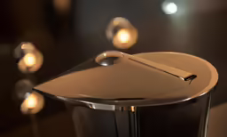 a silver plate is sitting next to several lights
