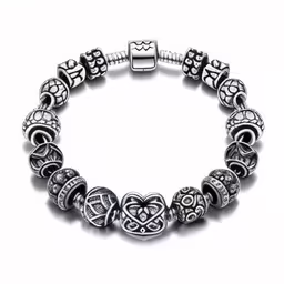 a bracelet with lots of charms on it,the silver bracelet is adorned with beads and charms