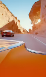 a vintage photo of a car driving down a mountain road