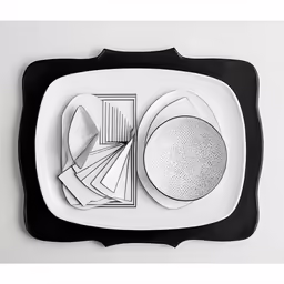 an empty white plate with a black edge and three circles
