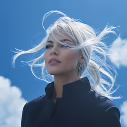 blond female with long hair blowing into the wind