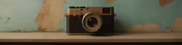 a camera is resting on the ledge in front of a wall