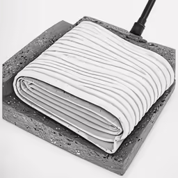 a folded blanket sitting on top of a stone block