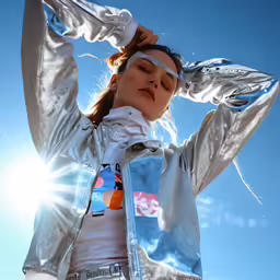 a girl stands in the sun, with her head raised