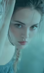 the face and shoulder of a woman with blue eyes