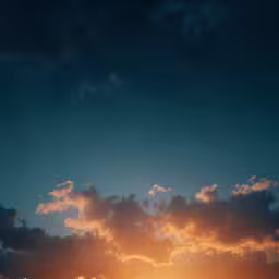 the sun is setting behind a hill in the background