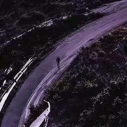 two people walking up a hill at night
