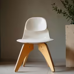 a white and wooden chair in front of a potted plant