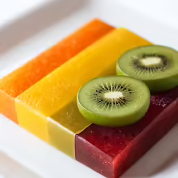 two slices of kiwi are in the colors of the rainbow