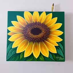 an artwork of a sunflower painted on a white wall,painting of a sunflower with a marker in the middle