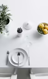 two chairs and a table with utensils in front of it