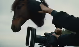 a person that is next to a horse