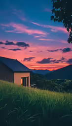 the house is set on a hillside at sunset