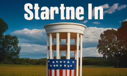 an american flag sits in front of the white pillar