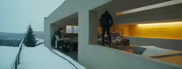 a view through two windows at people in winter