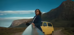 a woman leaning on a surfboard by the ocean