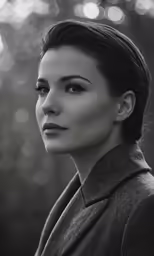 a black and white photo of a woman in a jacket