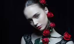 a beautiful young lady with red roses on her neck