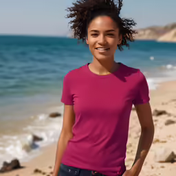 a girl on the beach smiles at the camera