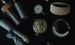 a close up of some food near a pocket watch