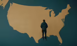 a person standing by a map of the united states