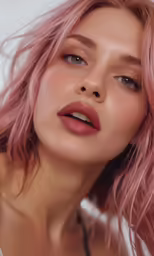 a close up of a woman with pink hair