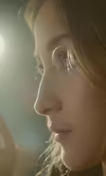 a beautiful woman in glasses looking off into the distance